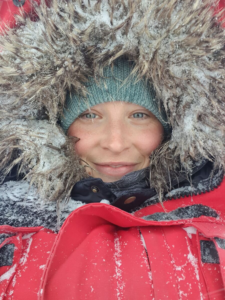 Kat smiling inside a frosted fur hood
